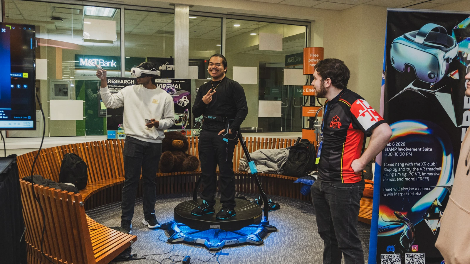 Students sharing a VR demonstration at a club event.