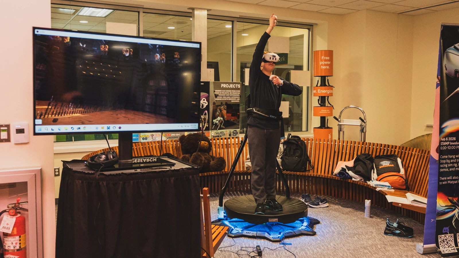 A visitor using the VR treadmill at a campus showcase.