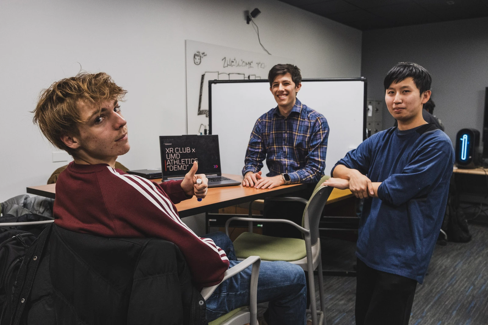 Students working together around a laptop in the XR lab.