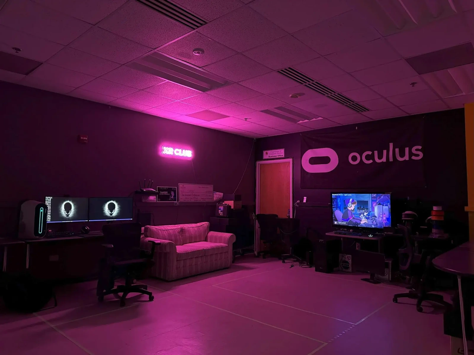 The XR Club lab with its Oculus banner and pink lighting.